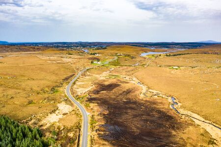 Aerial view of the road to Dungloe next to Loch Mhin Leic na Leabhar - Meenlecknalore Lough - County Donegal, Irelandの写真素材