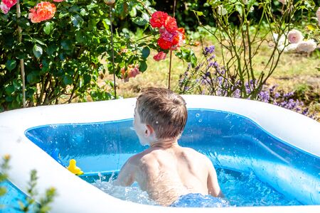 Young boy drowning in the swimming pool in the summer