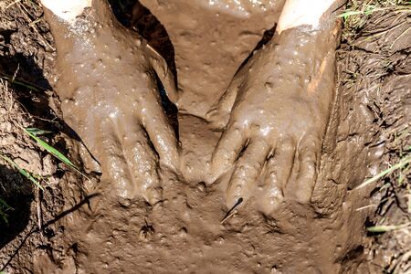 Boy working and playing in the mud