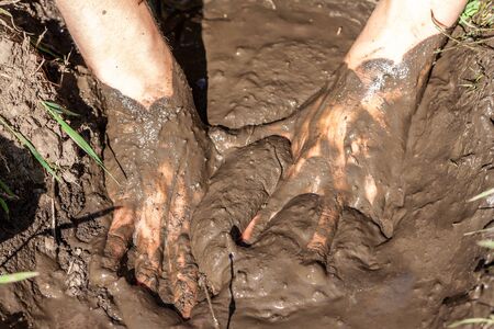 Boy working and playing in the mud.の写真素材