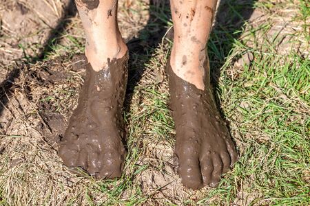 Boy working and playing in the mud.の写真素材