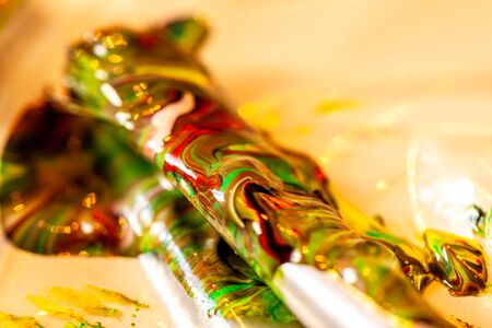 Close up of liquid artist colours on brush and potの写真素材