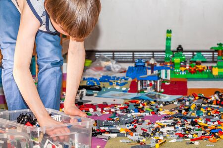 Essen / Germany - March 27 2019: Boy playing with Lego, plastic construction toys that are manufactured by The Lego Group in Billund, Denmarkのeditorial素材