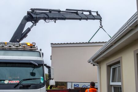 Ardara / Ireland - November 02 2019 : H2 buildings installing prefabric garage in the pooring rain