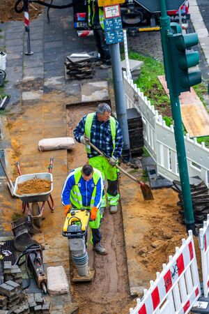 ESSEN / GERMANY - OCTOBER 07 2019 : Workers preparing the ground after the fibreglass installation.