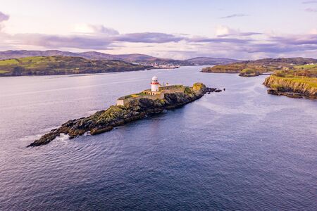 Aerial of the Rotten Island Lighthouse with Killybegs in background - County Donegal - Ireland.の写真素材