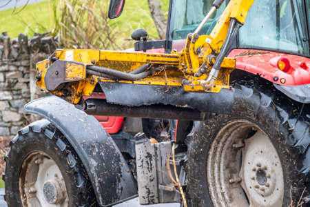 DONEGAL / IRELAND - MARCH 11 2020 : Huge machine cutting trees , bushes and gras along the road.のeditorial素材