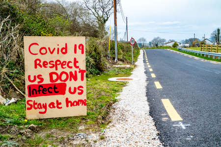 Portnoo, County Donegal / Ireland - April 10 2020 : Sign warning Covid 19 Respect us dont infect us stay at homeのeditorial素材