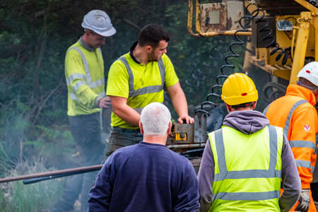 Donegal / Ireland - June 12 2020 : Builder trying to repair Asphalting paver machine during the reopening after Covid 19 lockdownのeditorial素材