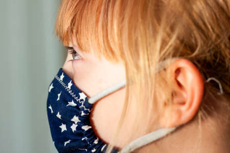 Close up of girl wearing a mask during the pandemicの写真素材