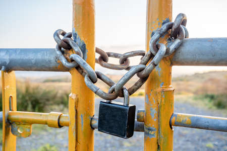 Padlock and chain at gate in wild Irelandの写真素材