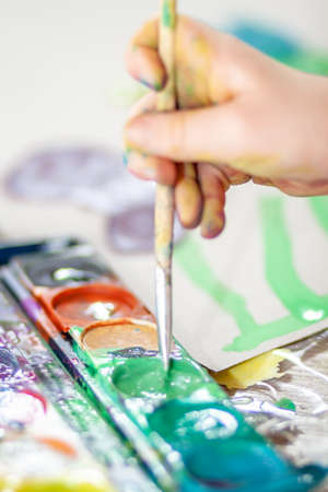 Little girl using watercolour at home during the pandemic lockdown