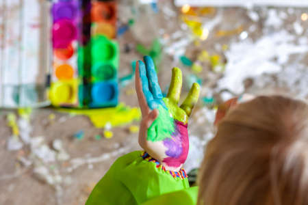 Little girl using watercolour at home during the pandemic lockdownの写真素材