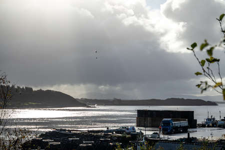 Killybegs / Ireland - November 04 2020 : Helicopter picking up Helicopter bucket and spreading...