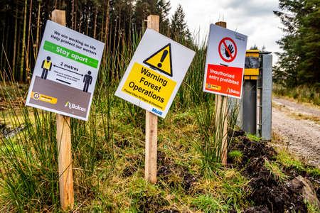 Lettermacaward, Ireland - November 03 2021 : Signs giving direction regarding forest operations and covid 19のeditorial素材
