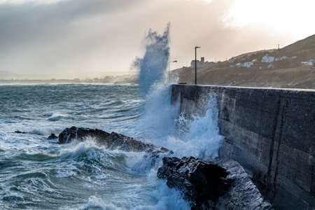 Waves crashing against the pier at Portnoo harbour after Storm Franklin - County Donegal, Republic of Irelandの写真素材