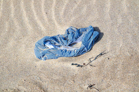 Lost swim trousers lying on the sandy beachの写真素材