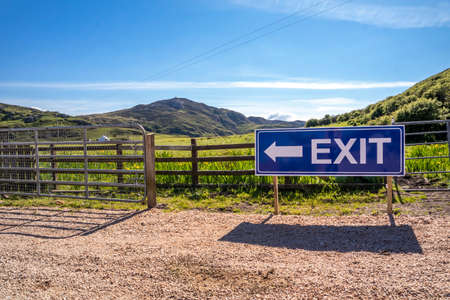 Exit sign on wooden fence of a farm and camping site