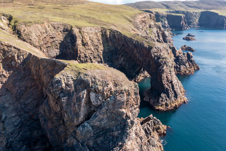 Aerial view of the cliffs near the lighthouse on the island of Arranmore in County Donegal, Irelandの写真素材