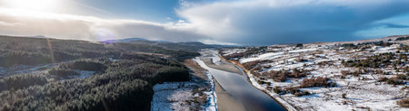 Aerial view of snow covered Gweebarra River between Doochary and Lettermacaward in Donegal - Ireland - The site of the new Cloughercor wind farm in the backgroundの写真素材