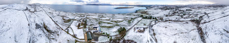 Aerial view of snow covered Dunmore Head, Bunaninver and Lackagh by Portnoo in County Donegal,...