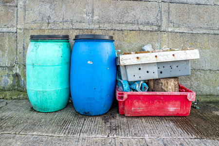 Storage boxes and barrels at irish harbour in County Donegal