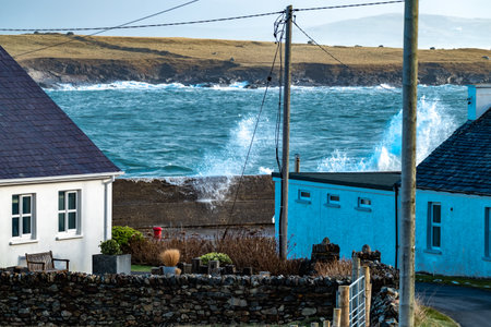 Waves crashing against the pier at Portnoo harbour after Storm Franklin - County Donegal, Republic of Irelandの写真素材