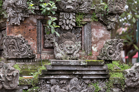 Ancient balinese ornaments partly jungle-covered