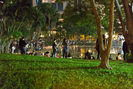 People celebrate Loi Krathong Festival in the Benchasiri Park, Bangkok