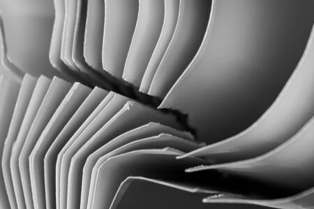 Curved sheets of paper in black and white detail - background.