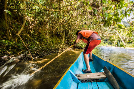 Tourists riding long boat on Merlinau river to Wind and Clear Water caves at Mulu National Park, Sarawakのeditorial素材