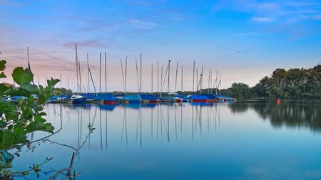 Sailing marina at the lake Unterbachersee in the city of Duesseldorf during the blue hour after sunset. NRW Germanyの写真素材