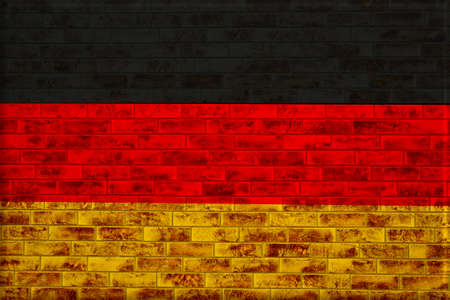 German flag on a brick wall. Three-dimensional illustration of the German flag. Black, red and yellow colors on a brick wallの写真素材