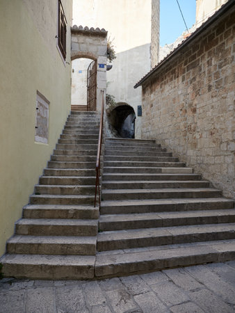 Omis, Croatia - July 23, 2021: Stairs in the old town of Omis leading to the Mirabela fortress. Croatian historic street.のeditorial素材