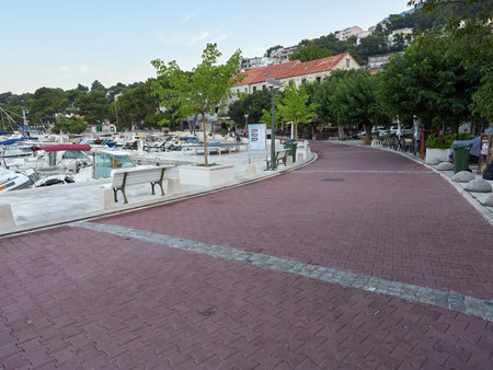 Brela, Croatia - July 24, 2021: The main promenade at the port in a seaside resort. Marina on the Adriatic Sea.のeditorial素材