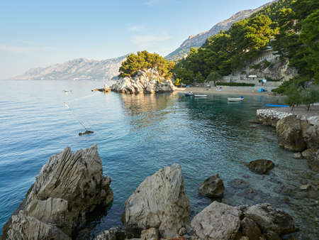 Paradise Beach Podrace surrounded by pine trees in the Croatian resort of Brela. Beautiful Adriatic...
