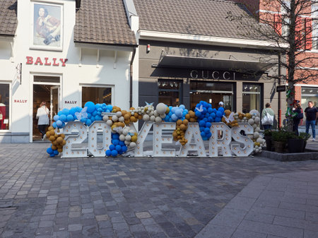 Roermond, The Netherlands, March 25, 2022 - Large "20 years" inscription decorated with colorful balloons at Designer Outlet Roermond.のeditorial素材