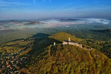 Bezdez castle and surrounding countryside with Machovo lake lake behind - aerial photo from ultralight plane in central Bohemian region in Czech Republic \ tのeditorial素材