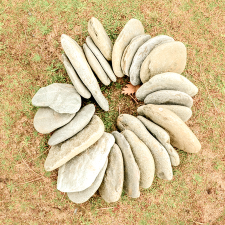 Magic stone circle shape on grass background, light pebblesの写真素材