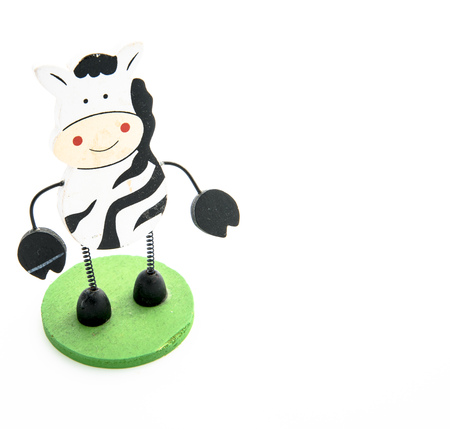 Wooden cow toy isolated on white backgroundの写真素材