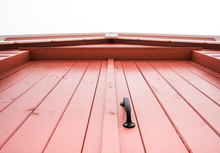 Vintage black handle on red wooden door