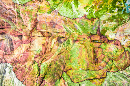 Green, red, orange sediments and minerals, rock formations - a colorful rocks stacked over the hundreds of yearsの写真素材