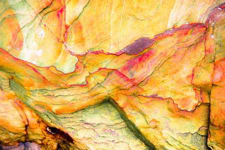 Orange, yellow, green, red sediments and minerals, rock formations - a colorful rocks stacked over the hundreds of yearsの写真素材