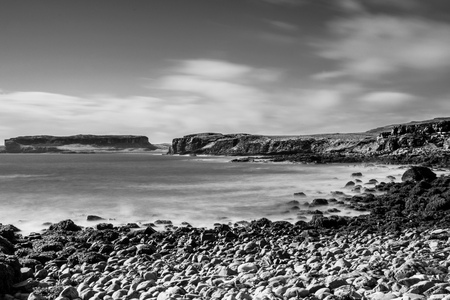 Wild coast of Scotland, cliffs and rocks of Isle of Skye, black and white long exposure shotの写真素材