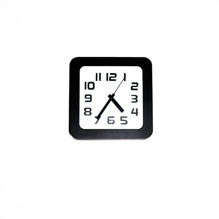 Wall clock - square black wall clock on a white wallの写真素材