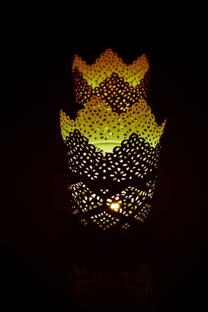 Candle flame in the dark background and space for text