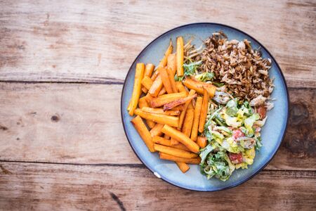 Healthy food, dinner for vegetarian - honey glazed carrots, green salad and basmati rice