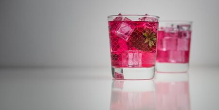 Vodka with strawberry cordial and lime lemonade in a glassの写真素材