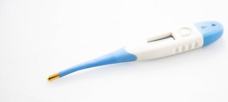 Alloa, Scotland - 14 August 2019: Electronic medical thermometer. Digital device for measuring the temperature of the human body. Isolated object. White background.の写真素材