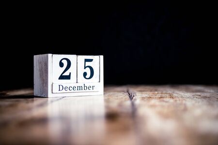 December 25th, 25 December, Twenty Fifth of December - White block calendar on vintage table - Date on dark backgroundの写真素材